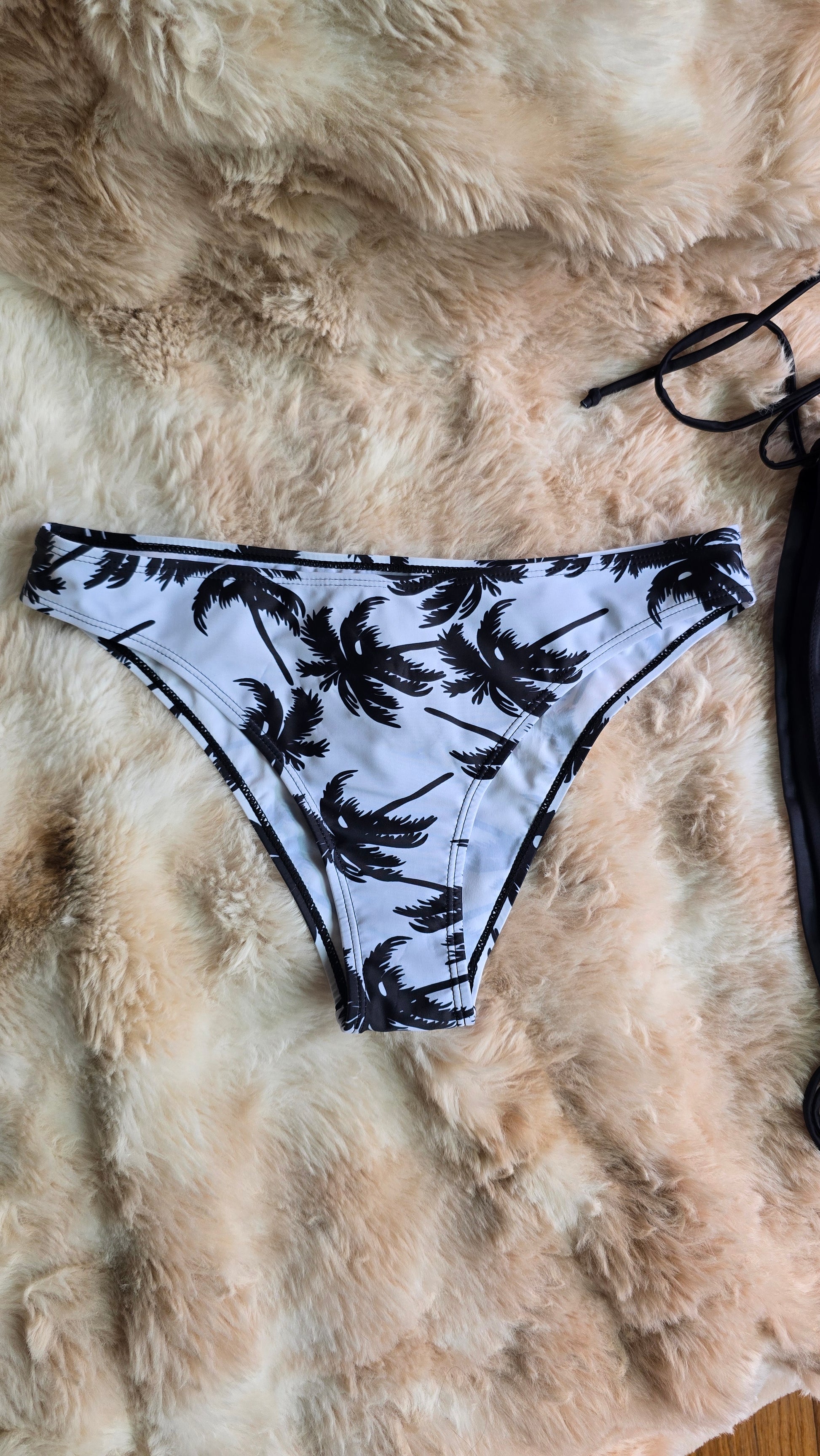 Black and white patterned bikini bottom on a fur surface